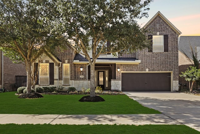 view of front facade with a garage and a yard