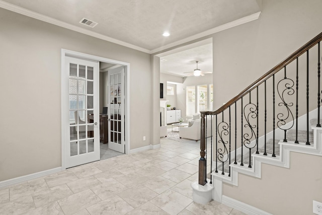 entryway featuring ornamental molding, french doors, and ceiling fan