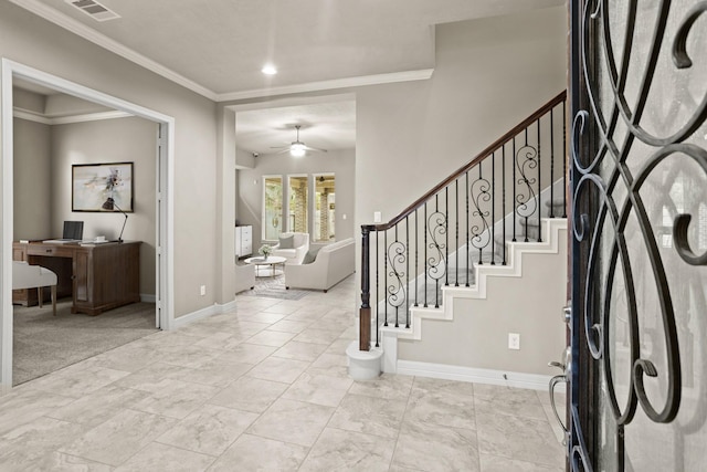 foyer featuring ceiling fan and crown molding