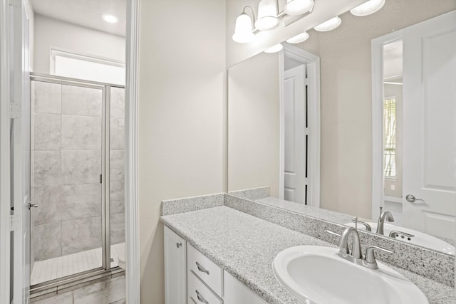 bathroom featuring a shower with door, vanity, and toilet