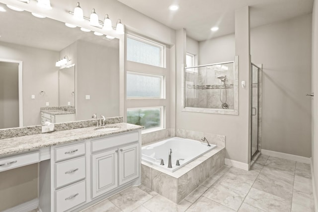 bathroom featuring vanity, separate shower and tub, and plenty of natural light