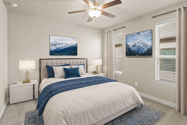 bedroom with light carpet and ceiling fan