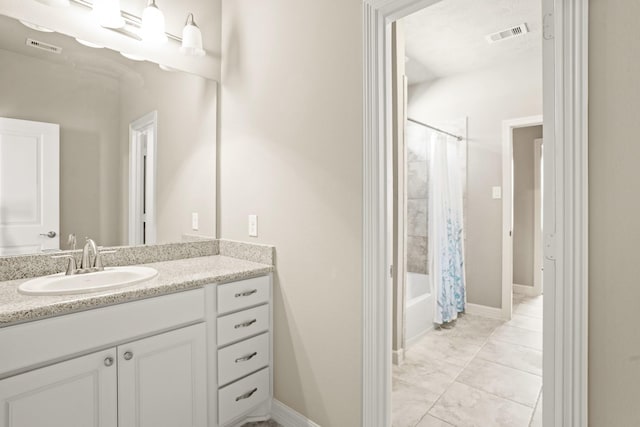 bathroom with shower / bath combo with shower curtain and vanity