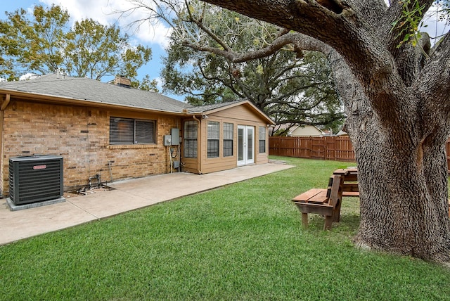 view of yard with cooling unit and a patio