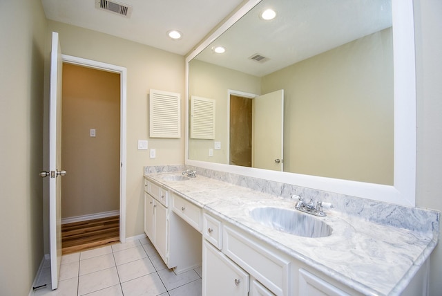 bathroom with tile patterned floors and vanity