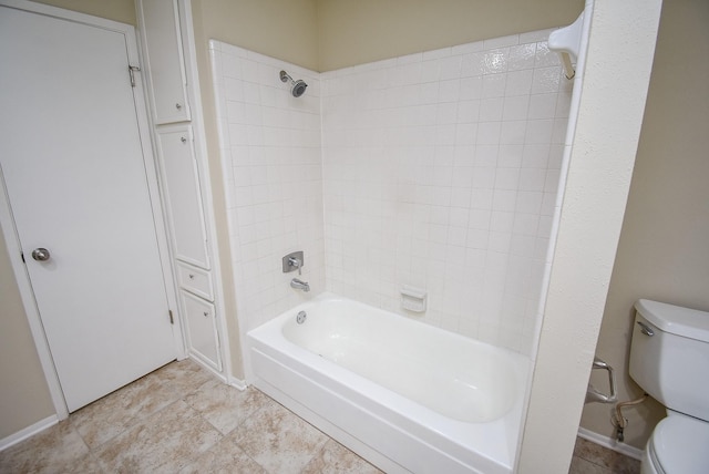 bathroom with washtub / shower combination and toilet