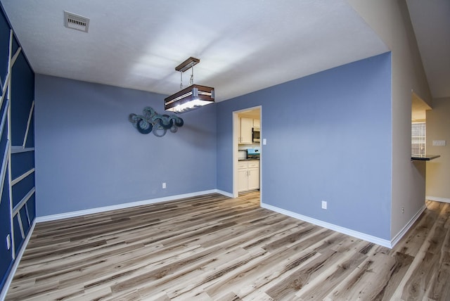 spare room with hardwood / wood-style flooring