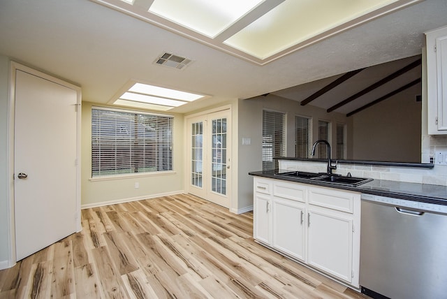 kitchen with stainless steel dishwasher, light wood-type flooring, white cabinetry, and sink