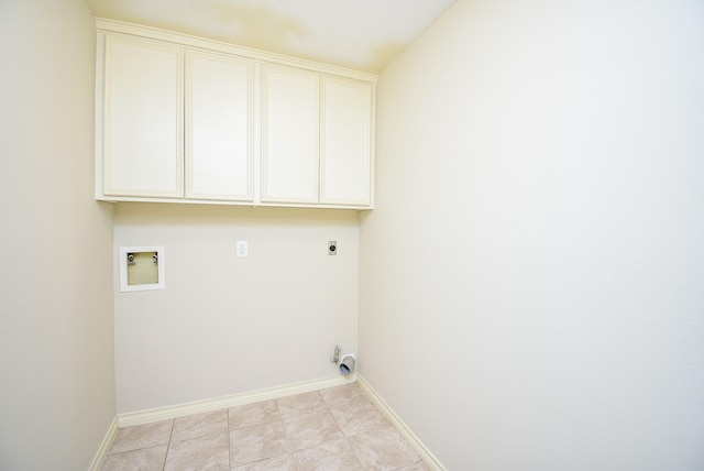 laundry area featuring hookup for a washing machine, light tile patterned floors, cabinets, and hookup for an electric dryer