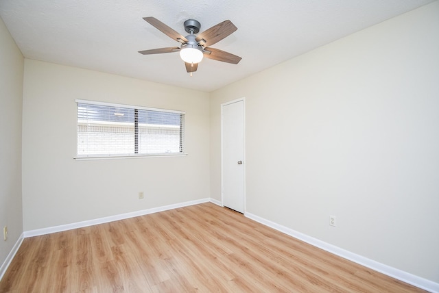 empty room with light wood-type flooring and ceiling fan