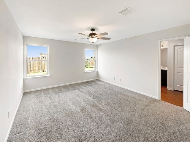 unfurnished room with carpet and ceiling fan