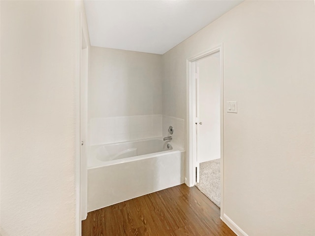 bathroom featuring a tub to relax in and hardwood / wood-style flooring