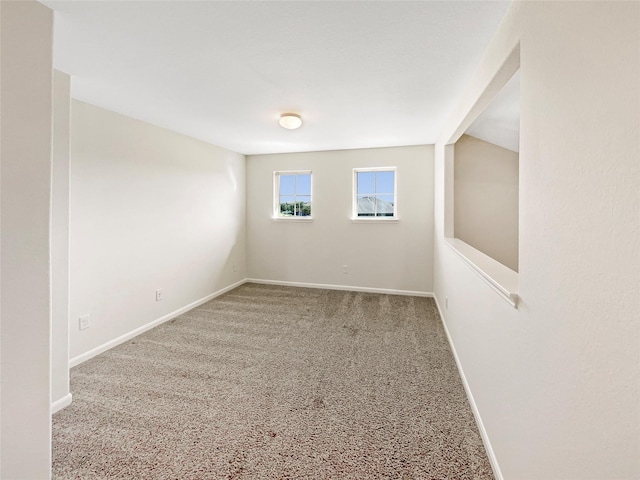 carpeted empty room with vaulted ceiling