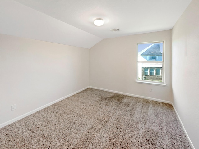 additional living space with carpet flooring and lofted ceiling