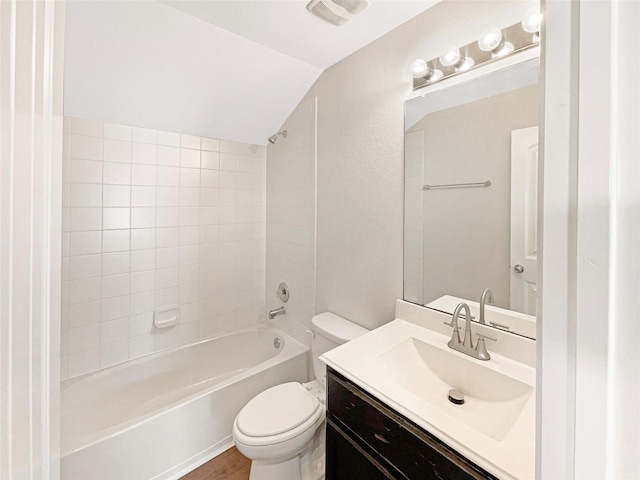 full bathroom with hardwood / wood-style floors, shower / bath combination, vaulted ceiling, toilet, and vanity