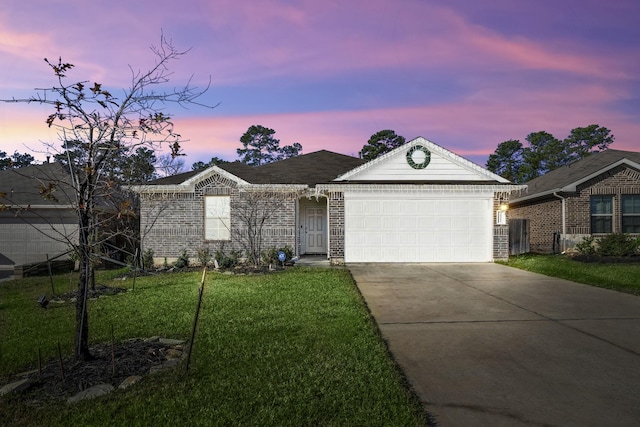 ranch-style house with a garage and a lawn