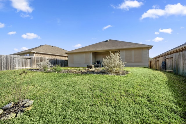 rear view of property with a lawn