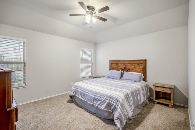 carpeted bedroom with ceiling fan and lofted ceiling