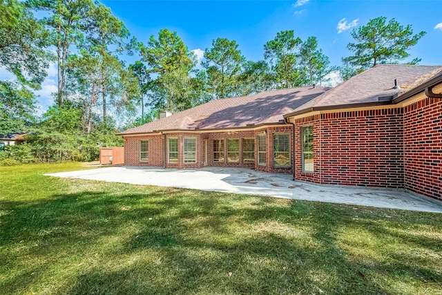 back of property with a patio and a lawn