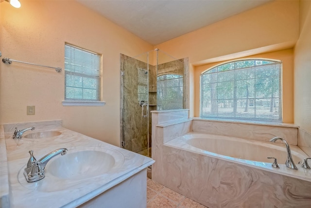 bathroom featuring tile patterned flooring, vanity, and shower with separate bathtub