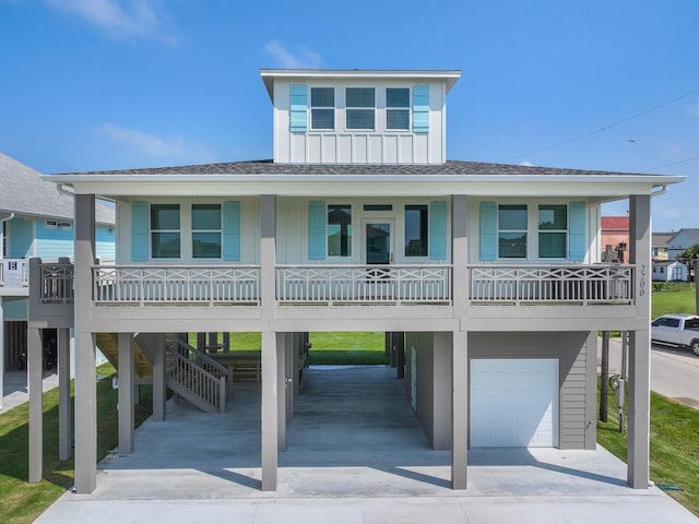 coastal home featuring a porch and a garage