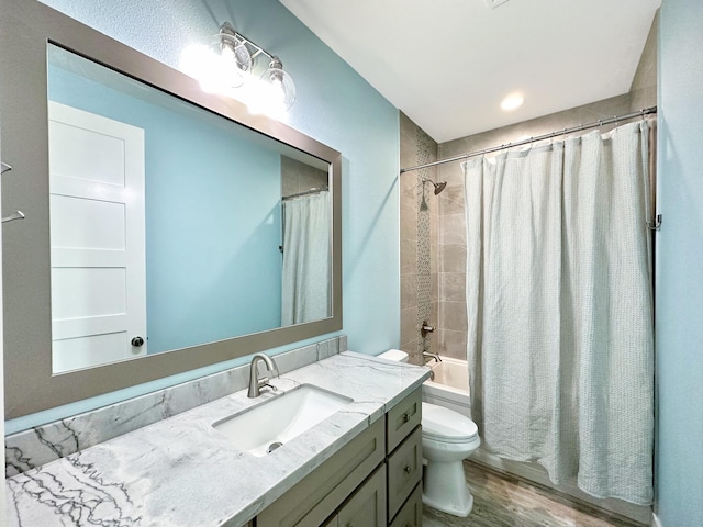 full bathroom featuring shower / bath combination with curtain, vanity, toilet, and hardwood / wood-style floors