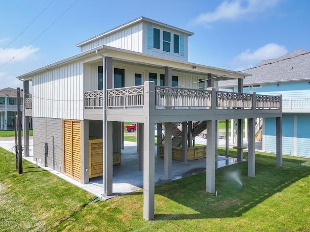 back of house featuring a lawn and a wooden deck