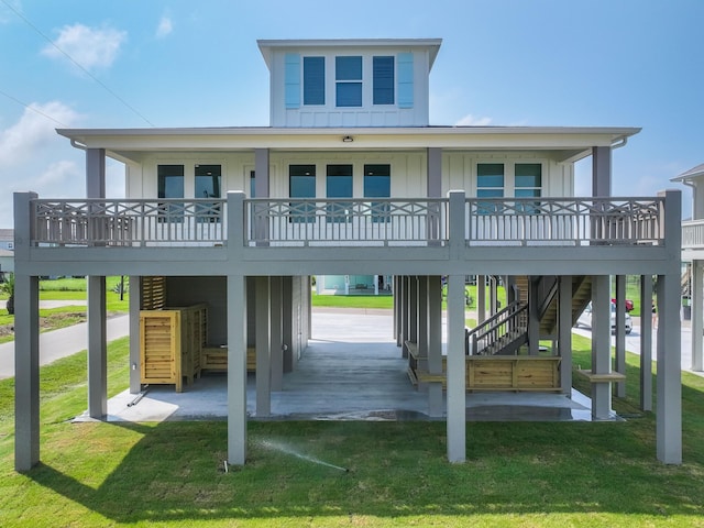 back of property with a carport and a lawn