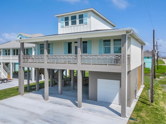 raised beach house with a porch and a garage