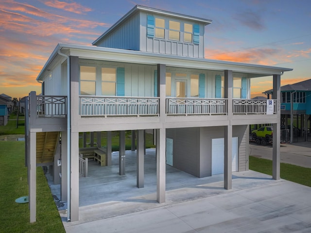 back house at dusk with a balcony and a garage