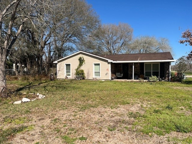 ranch-style home featuring a front yard