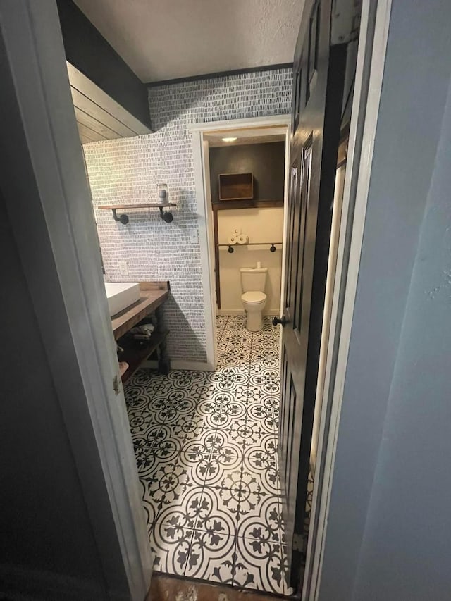 bathroom featuring tile patterned flooring and toilet