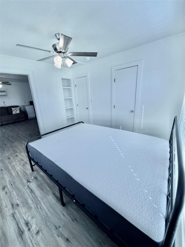 bedroom featuring hardwood / wood-style flooring and ceiling fan