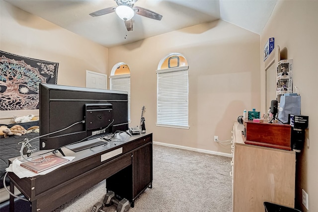 home office featuring ceiling fan, light colored carpet, and vaulted ceiling