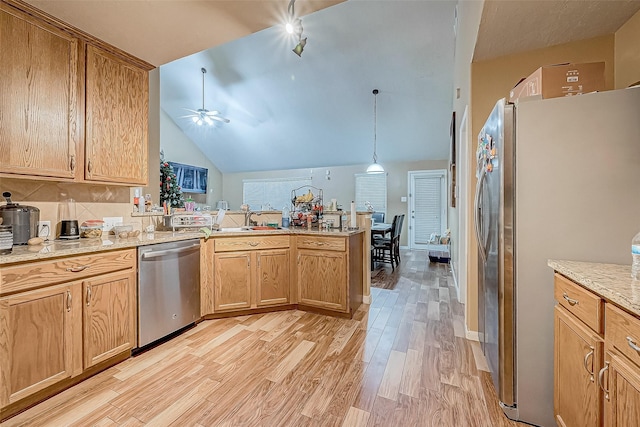 kitchen featuring ceiling fan, hanging light fixtures, stainless steel appliances, kitchen peninsula, and light wood-type flooring