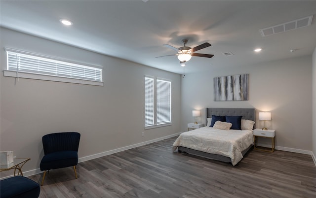 bedroom with dark hardwood / wood-style floors and ceiling fan