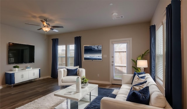 living room featuring dark hardwood / wood-style flooring and ceiling fan