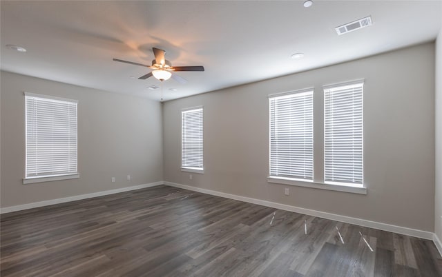 empty room featuring ceiling fan and dark hardwood / wood-style floors