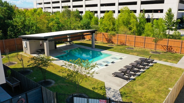 view of swimming pool featuring a yard and a patio area