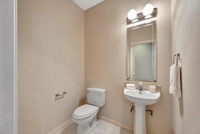 bathroom featuring tile patterned flooring and toilet