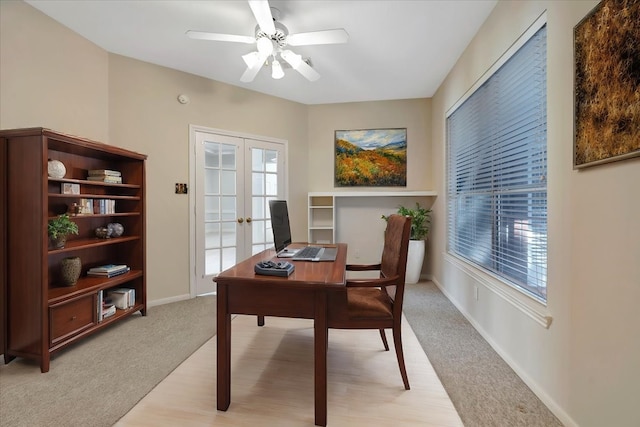 carpeted office space with ceiling fan and french doors