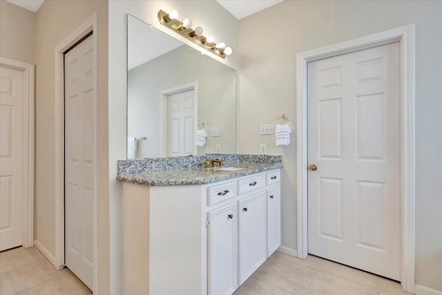 bathroom featuring tile patterned flooring and vanity