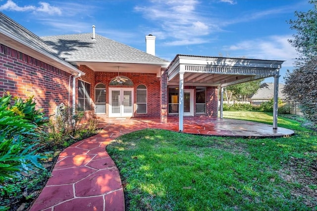 exterior space with french doors, a yard, and a patio area