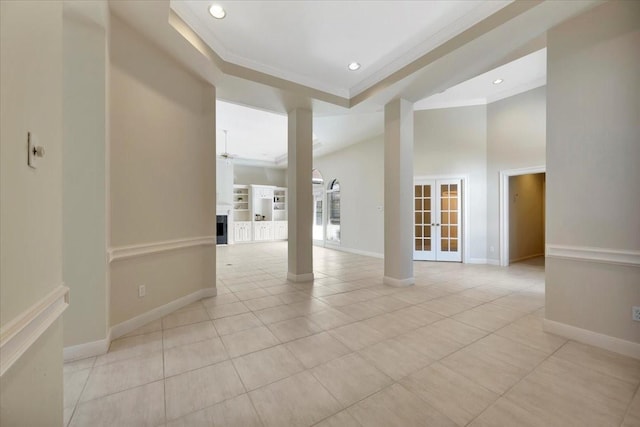 unfurnished room featuring ceiling fan, a towering ceiling, light tile patterned floors, and ornamental molding