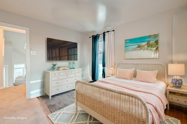 bedroom with light wood-style flooring and baseboards