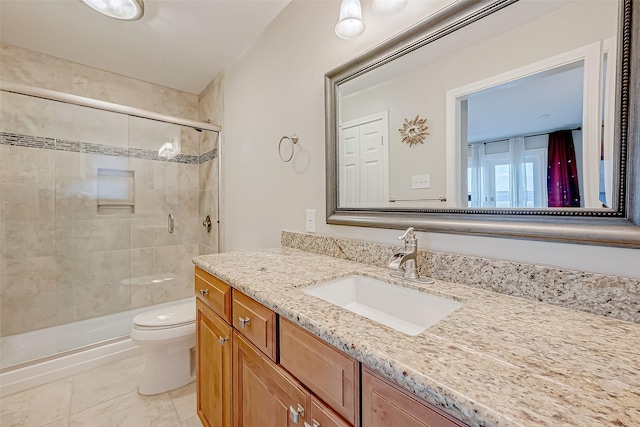 bathroom featuring toilet, a stall shower, tile patterned flooring, and vanity