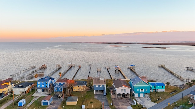 aerial view at dusk with a water view