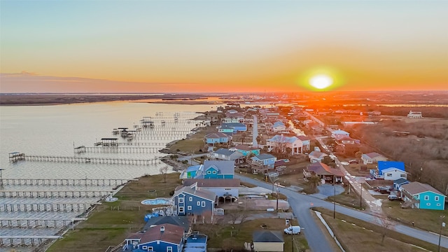 aerial view at dusk with a water view