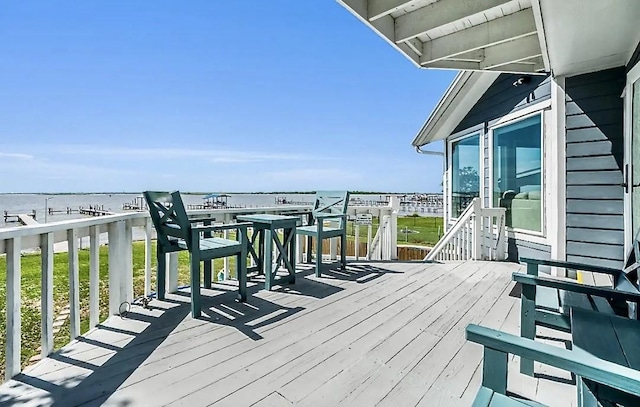 wooden terrace featuring a water view