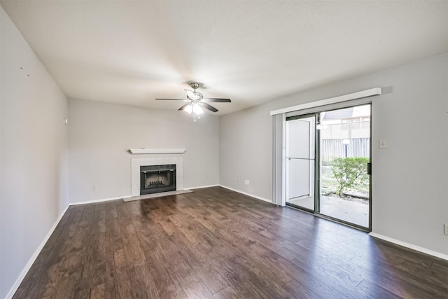 unfurnished living room featuring dark hardwood / wood-style flooring, ceiling fan, and a fireplace